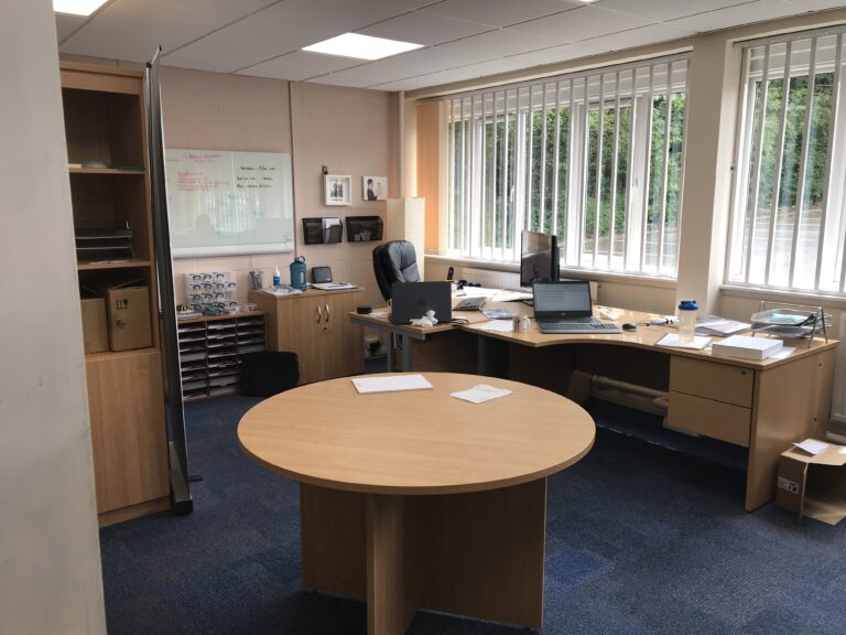 Meeting table and desks at our first premises